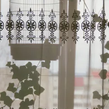 Birdcage hanging behind a decorative curtain related to Park Designs for Window Valances
