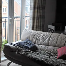 black and gray blanket on gray couch related to Plaid Curtain Valances: Adding a Touch of Rustic Charm to Your Home