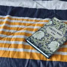 black and white book on white and brown textile related to What is a Matelasse Coverlet? A Comprehensive Guide