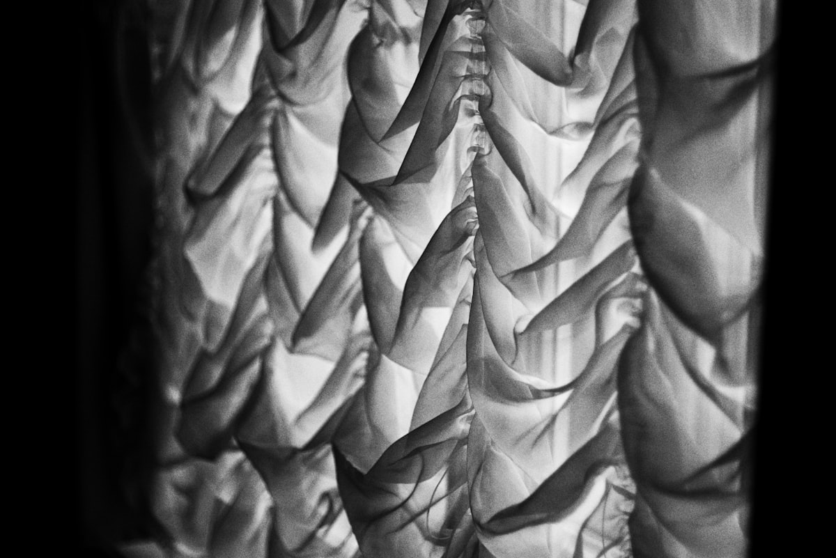 Black and white draped fabric with dramatic lighting. related to Master the Ruffled Valence: A Step-by-Step Guide