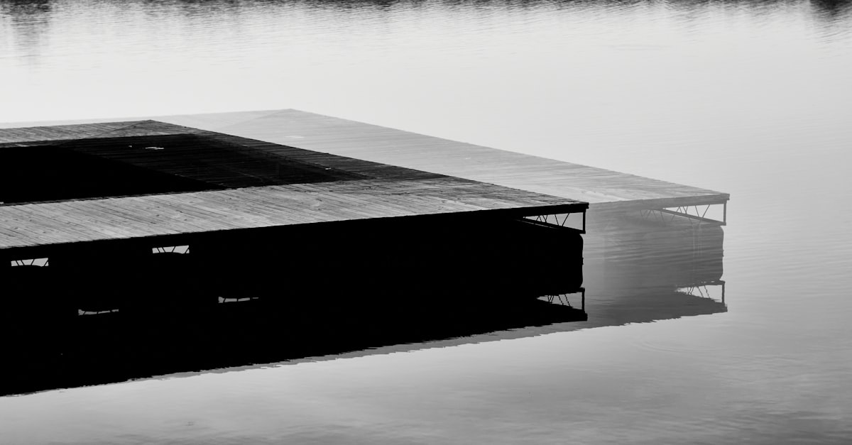 black and white wooden dock on calm water related to Floating Above Reality: Exploring Magnetic Floating Beds