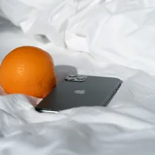 black asus laptop beside orange fruit related to Transform Your Bedroom with Vibrant Orange Bedding Sets