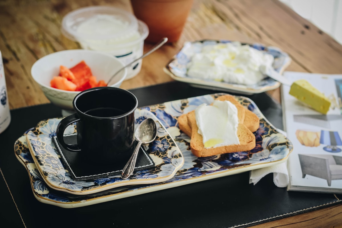 black ceramic mug on white ceramic plate related to Ballaine House Bed and Breakfast: A Hidden Gem of Comfort and Charm