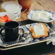 black ceramic mug on white ceramic plate related to Ballaine House Bed and Breakfast: A Hidden Gem of Comfort and Charm
