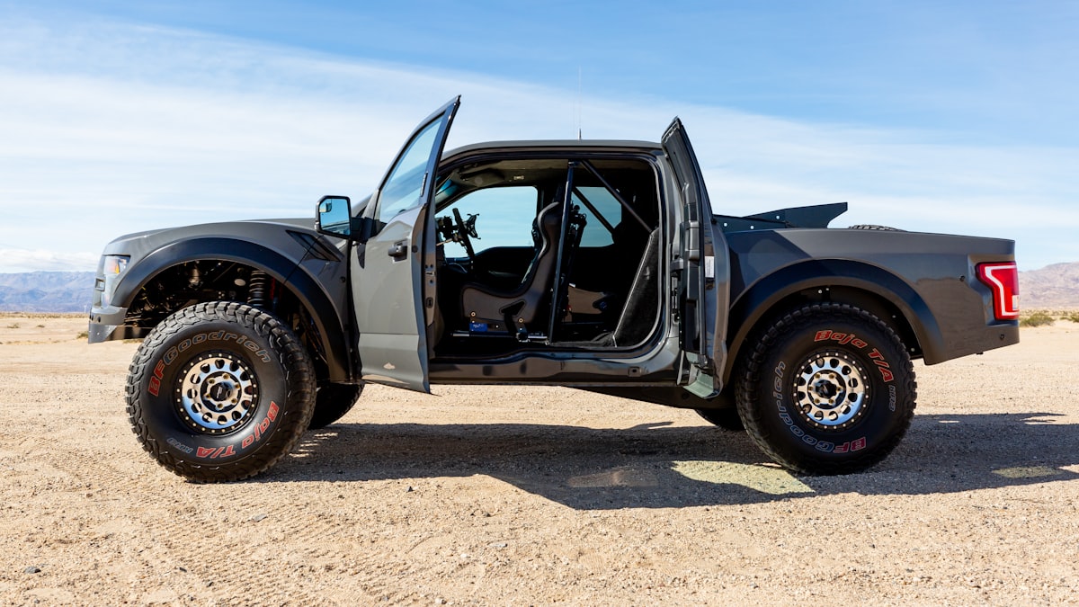 black classic car on brown sand during daytime related to UPOL Raptor Bed Liner: The Ultimate Protection for Your Truck