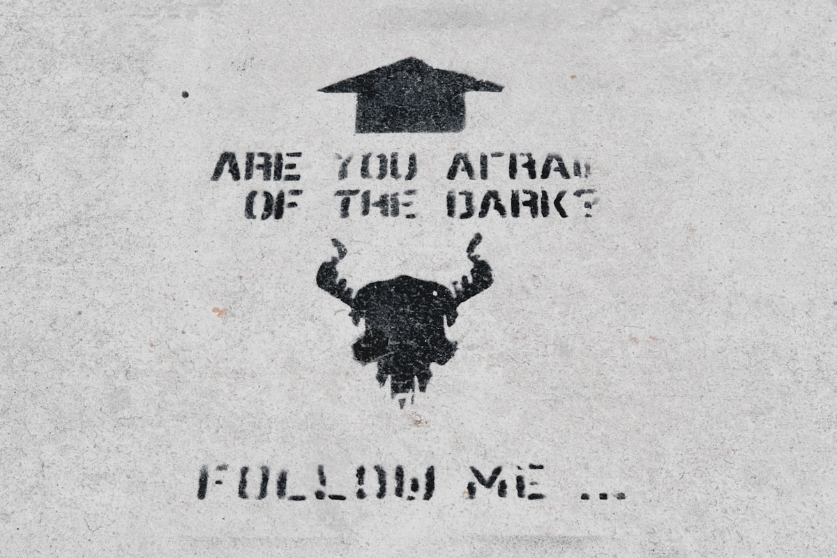 Black graffiti quote on the concrete   related to The Dark Side ofTan: Understanding the Risks of UVB Tanning Beds