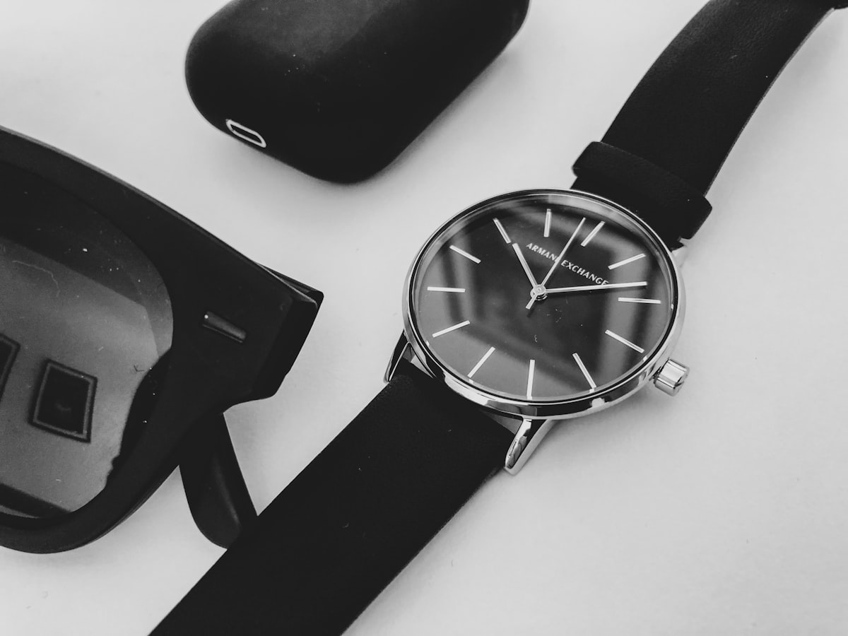 black round analog watch with black leather strap related to Timeless Style Meets Everyday Functionality
