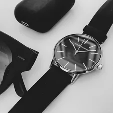 black round analog watch with black leather strap related to Timeless Style Meets Everyday Functionality