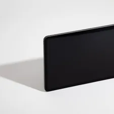 black tablet computer on white table related to Elegance in Dark: The Allure of Black Glass Sideboards