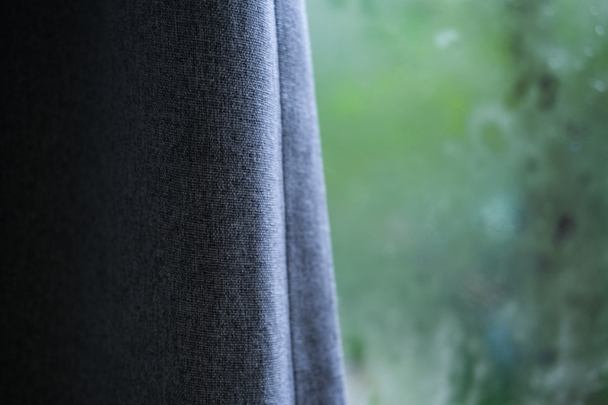 black textile near green grass field during daytime related to Dark Grey Valance: A Timeless and Versatile Window Treatment