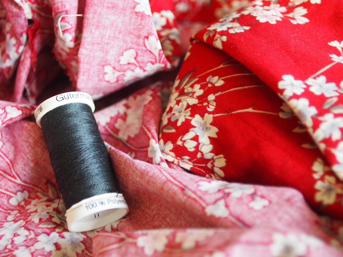 black thread on red and white floral textile related to Sew a Beautiful Valance: A Step-by-Step Guide