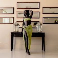 Black woman in a green dress related to Elegant Decor: The Beauty of Black Lace Valance