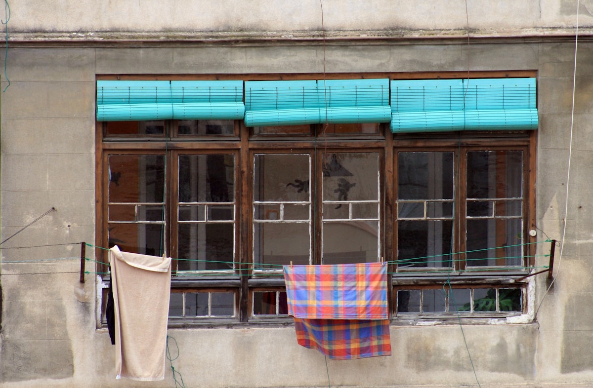 blue and red towel hanging near window related to Turquoise Valance Curtains