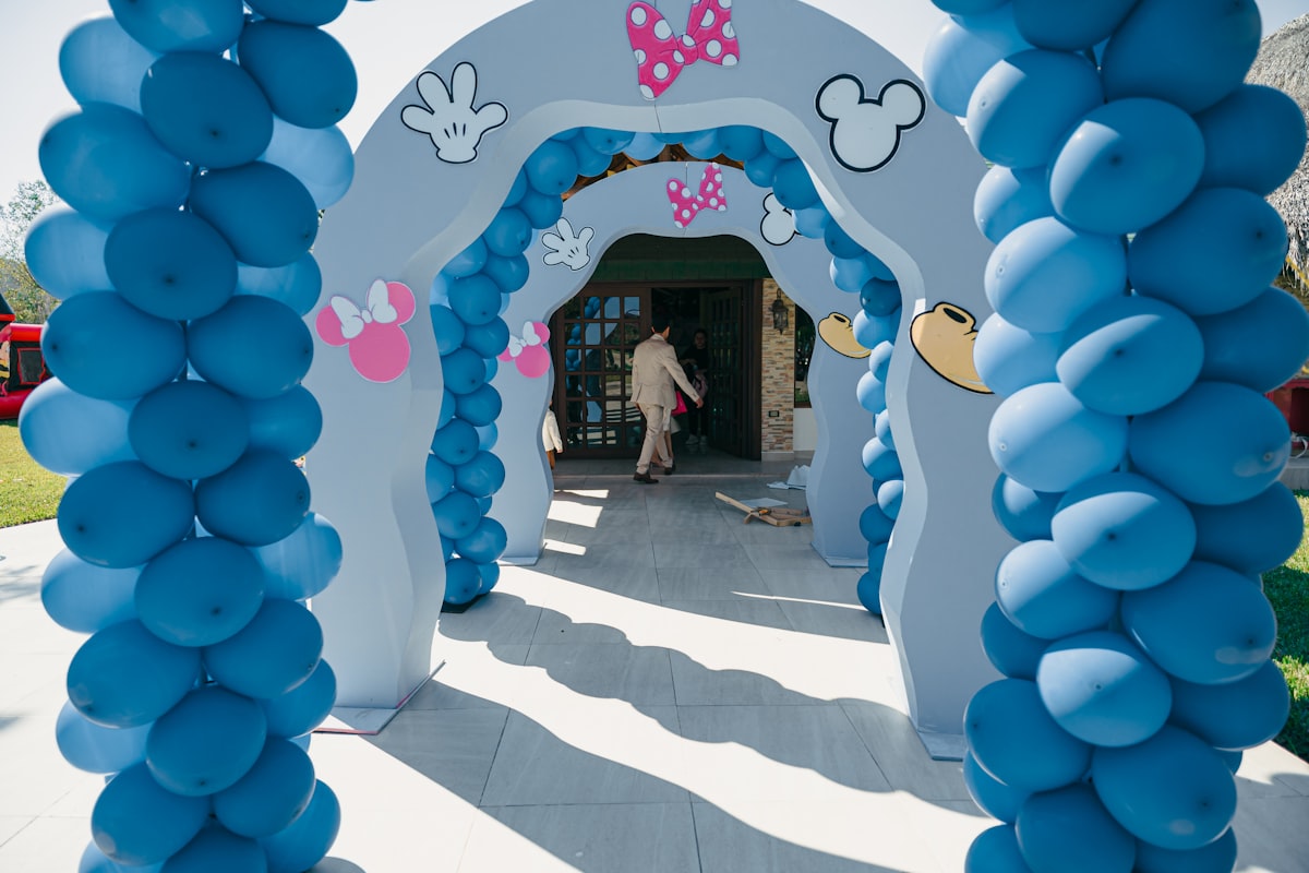 Blue balloon archway decorated with mickey mouse theme related to Dreaming of Disney: The Ultimate Guide to Minnie Mouse Bed