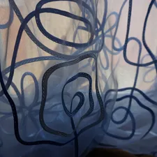 Blue sheer curtain with abstract dark blue floral pattern related to The Ultimate Guide to Curtain Scarf Valances: Transforming Your Windows with Style