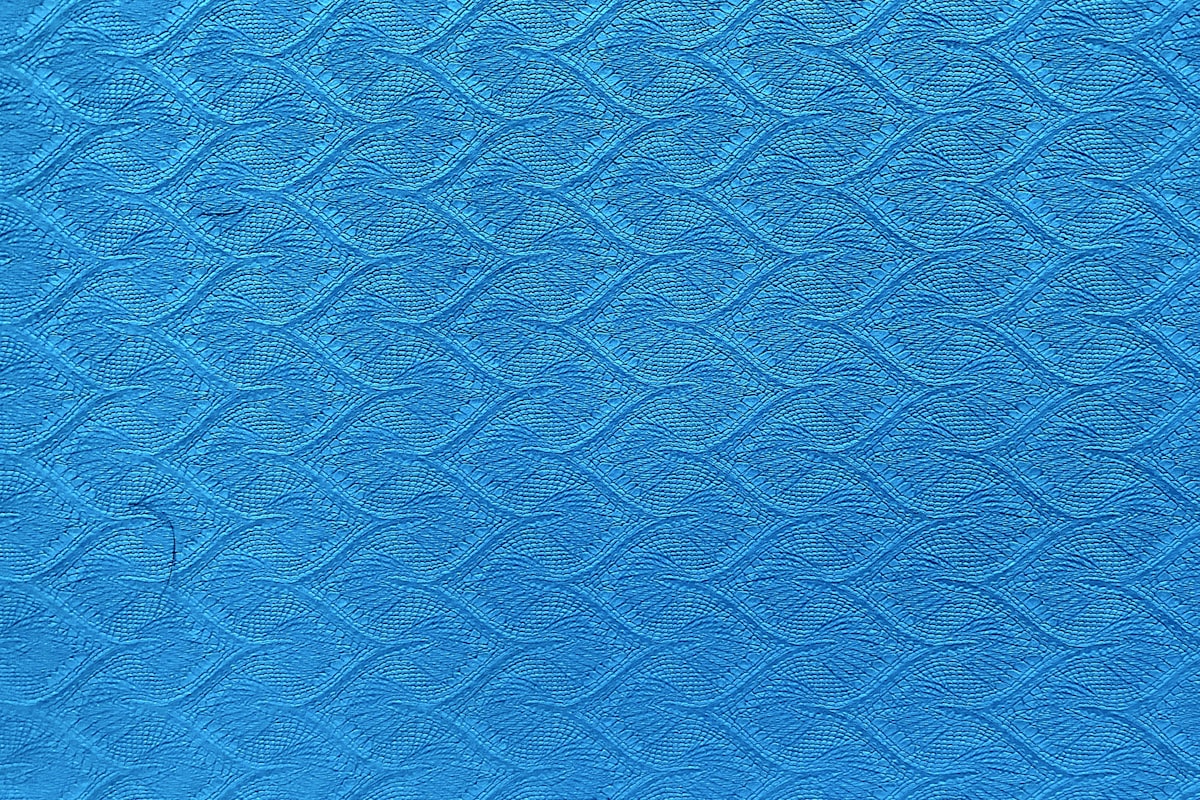 blue textile in close up photography related to Turquoise Quilted Coverlet: Elegant Bedding for Any Room