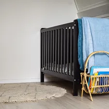 blue textile on brown wooden chair related to Attach the Bassinet to Bed: Essential Features and Benefits