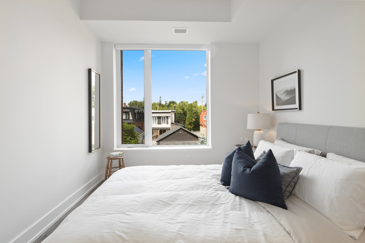 blue throw pillow on white bed related to Exploring Bed-Stuy Real Estate: The New Hotspot for Investors and Homebuyers