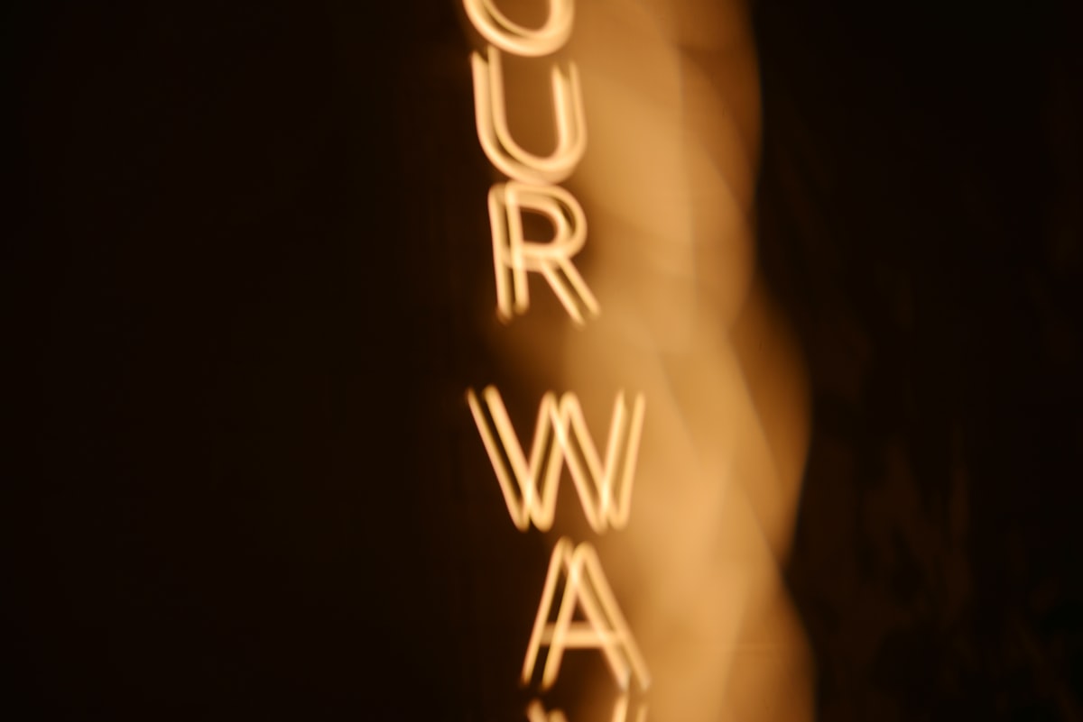 Blurred text spelling out 'our way' vertically related to Elevate Your Space with Vertical Blinds Valance