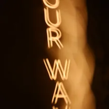 Blurred text spelling out 'our way' vertically related to Elevate Your Space with Vertical Blinds Valance