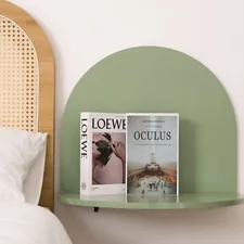 Books and decor on a stylish, green wall shelf. related to Maximizing Space: The Ultimate Guide to Over Bed Shelves