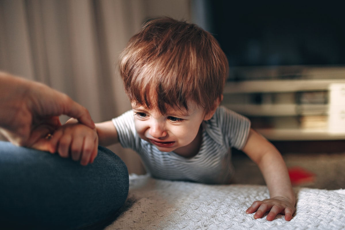boy in gray and white striped shirt sitting on floor related to Clever Options: Crib Alternatives for Tiny Tot's Transition
