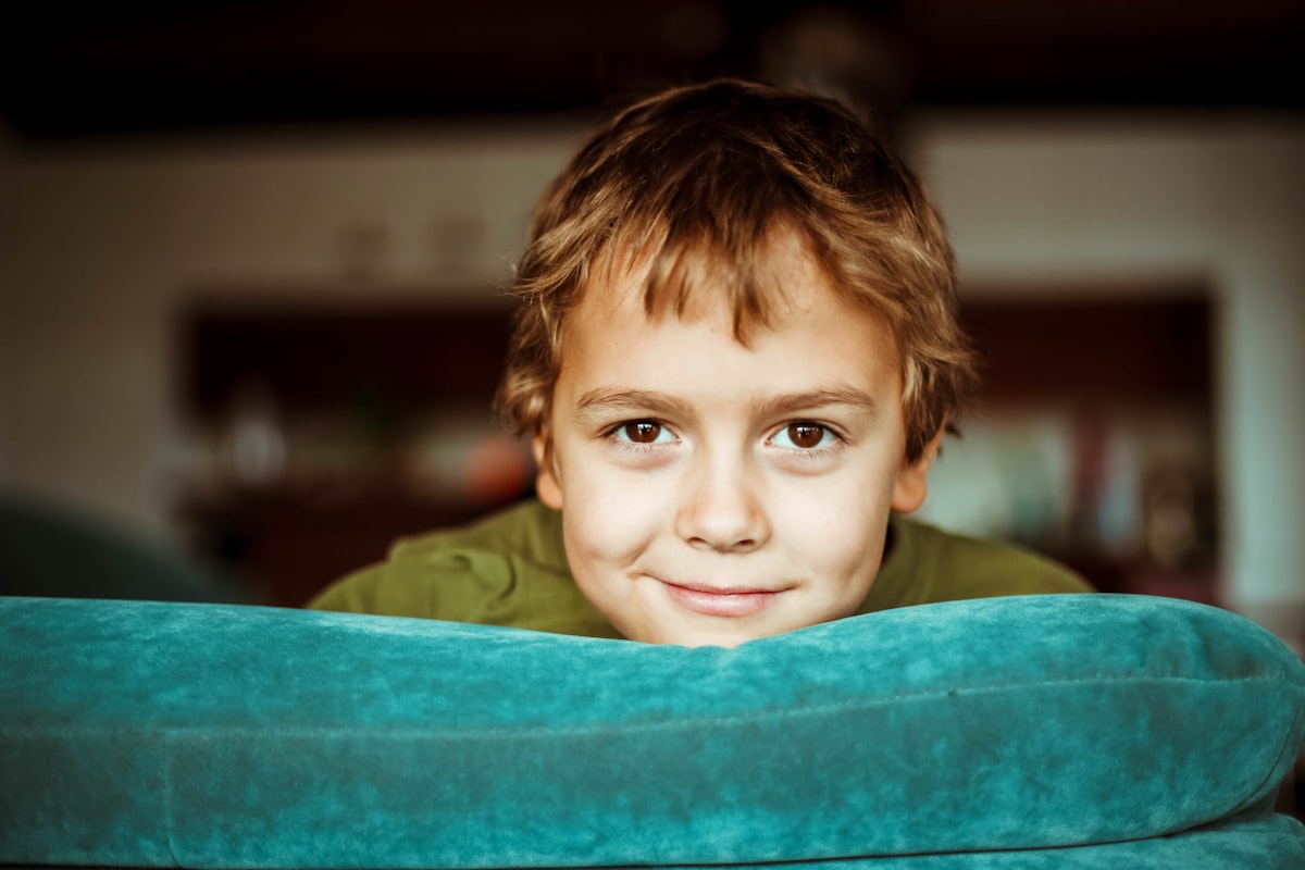 boy in green shirt smiling related to The Ultimate Sleeping Solution: Lazy Boy Sofa Bed