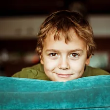 boy in green shirt smiling related to The Ultimate Sleeping Solution: Lazy Boy Sofa Bed
