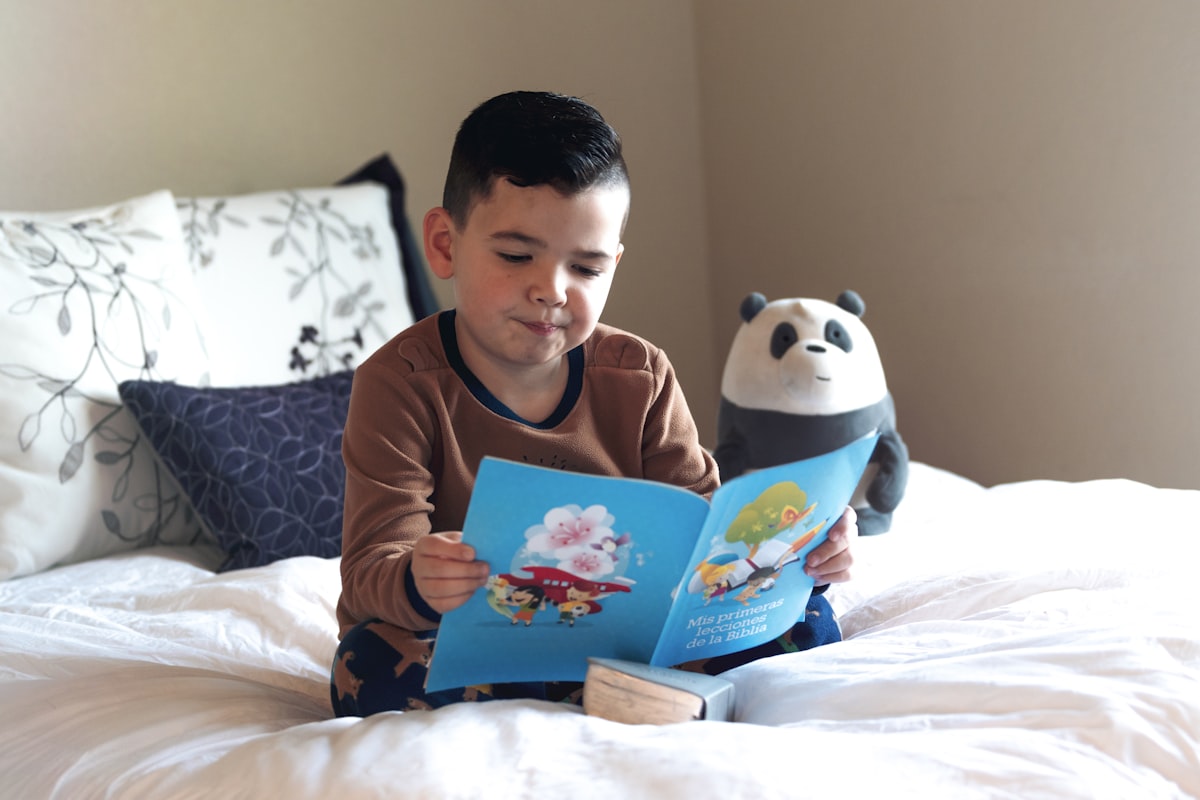 boy reading in his bed related to The Ultimate Guide to Bed Reading Pillows