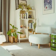 Bright, cozy room with plants and a white chair. related to Transform Your Space with Bedroom Curtains and Valances