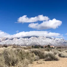 brown and white mountains under blue sky and white clouds during daytime related to Discover the Charm of Bed and Breakfasts in Albuquerque