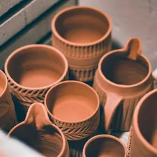 brown ceramic mugs on brown wooden shelf related to Where to Buy Clay Chiminea: A Comprehensive Guide