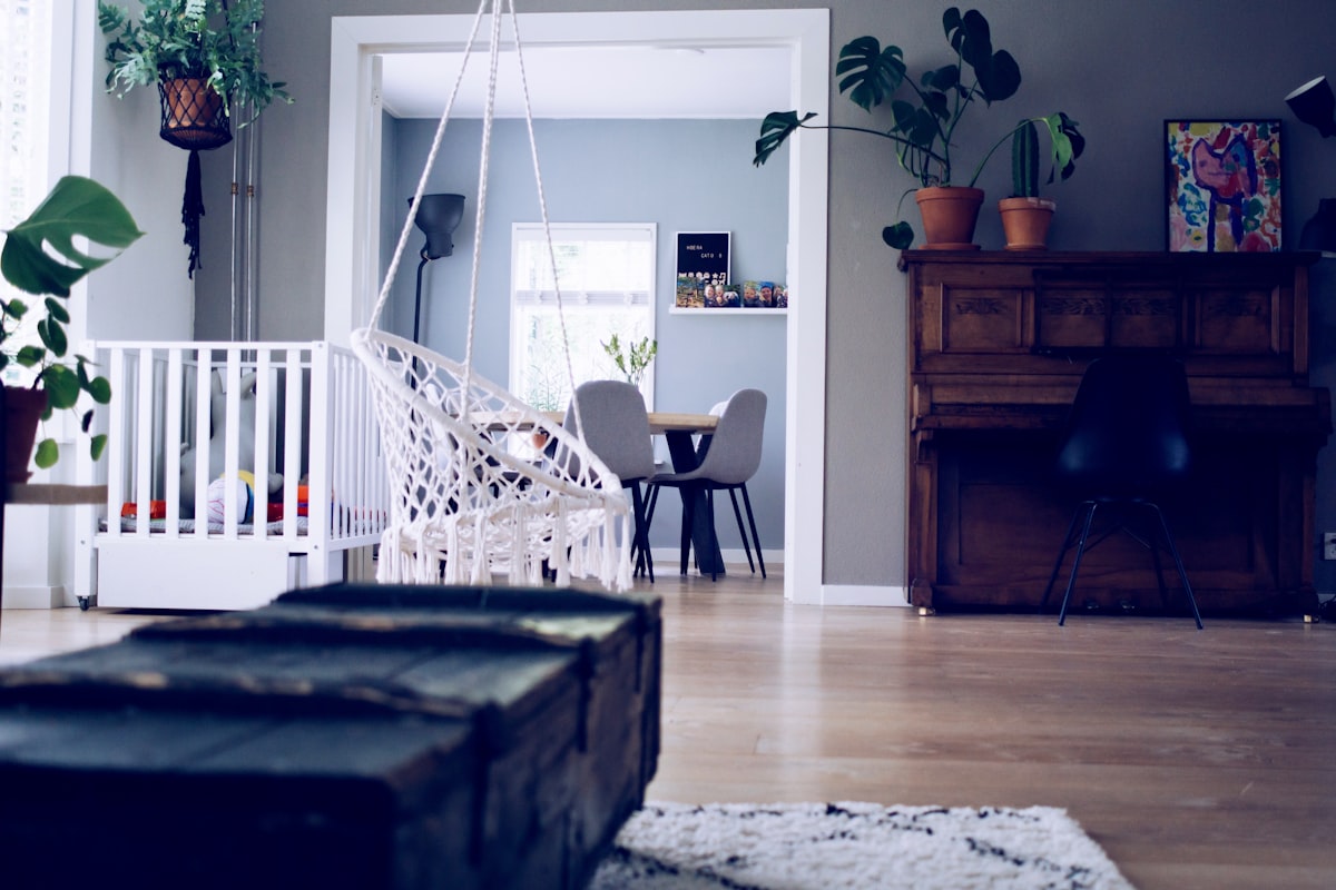 brown chest box beside swing related to Elevating Your Baby's Room with Adorable Valances