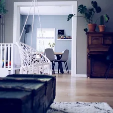 brown chest box beside swing related to Elevating Your Baby's Room with Adorable Valances