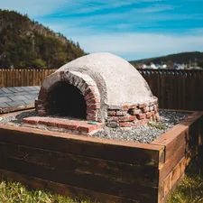 brown concrete brick on brown wooden fence related to Pizza Oven Chiminea: The Ultimate Outdoor Cooking Experience