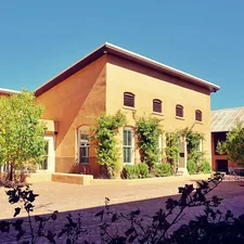 brown concrete building near green trees during daytime related to Exploring Bed Bath & Beyond in Albuquerque: A Shopper's Guide