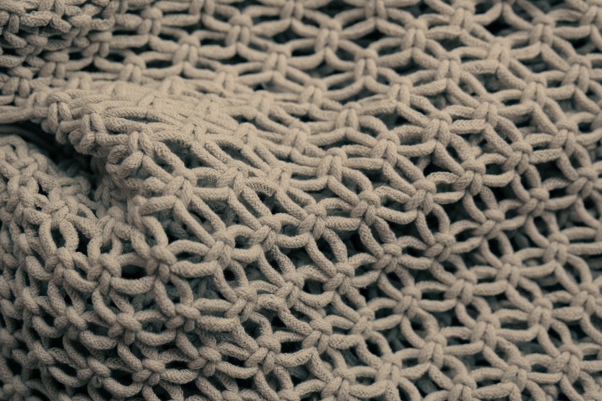 brown knit textile in close up photography related to Elevate Your Bedroom Décor with Handmade Elegance