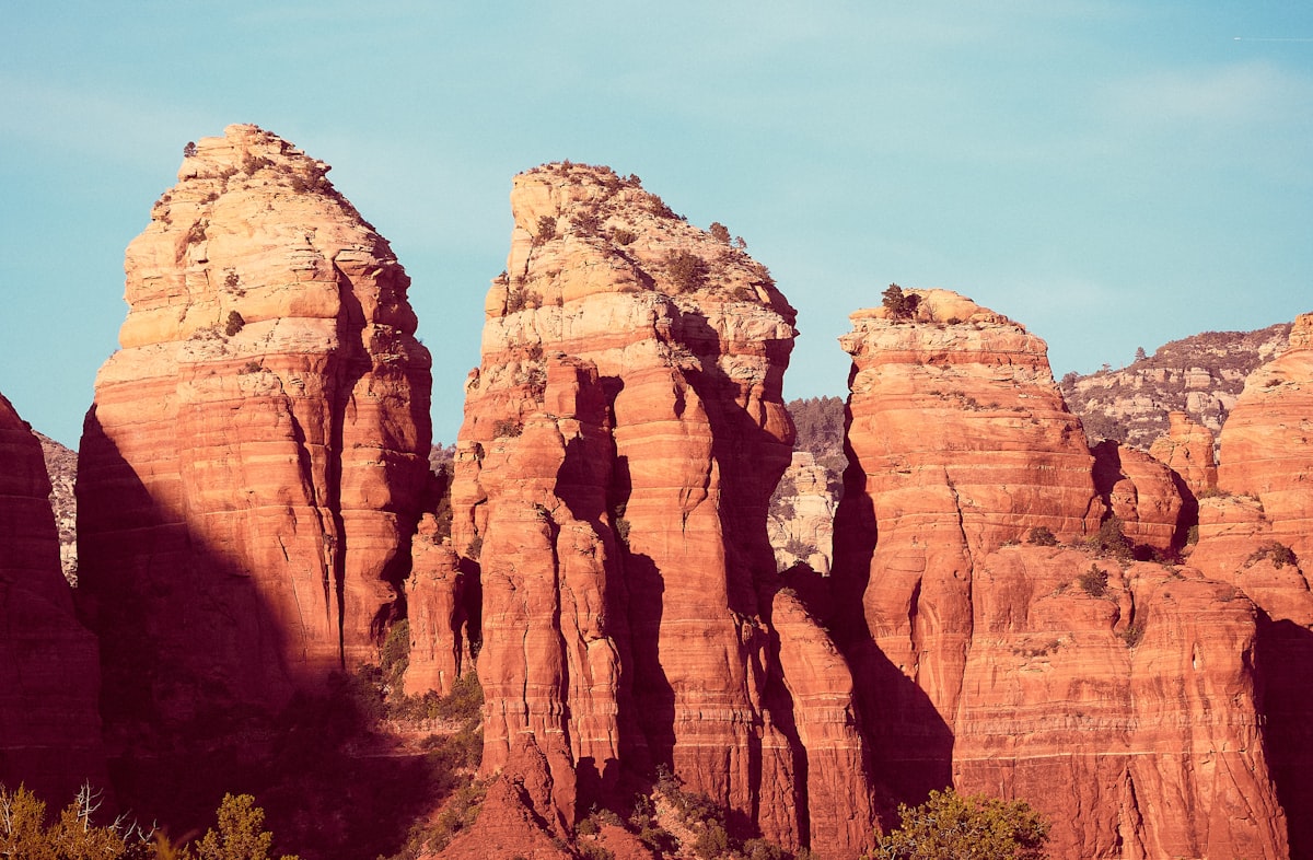 brown rock formation under blue sky during daytime related to A Cozy Getaway: The Best Bed and Breakfasts in Sedona, AZ