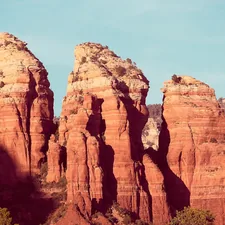 brown rock formation under blue sky during daytime related to A Cozy Getaway: The Best Bed and Breakfasts in Sedona, AZ