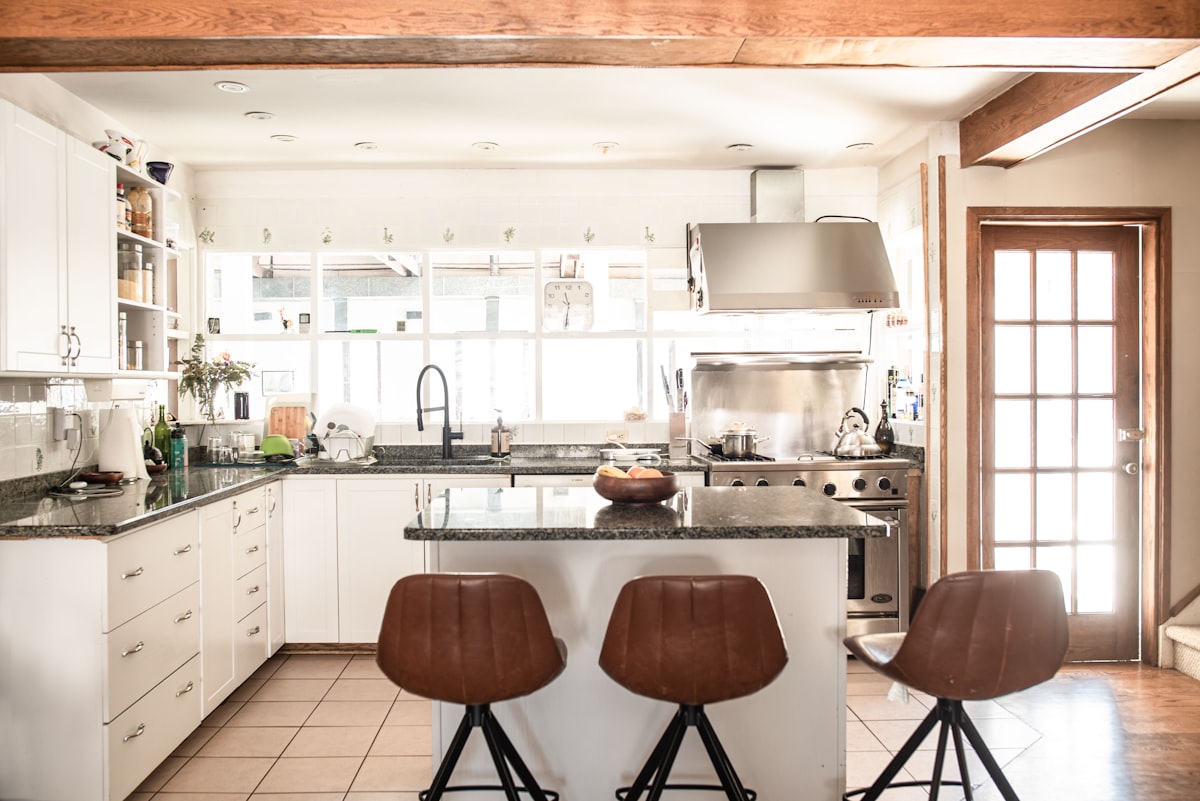 brown wooden bar stools beside kitchen counter related to Elevate Your Kitchen Style with Modern Kitchen Valances