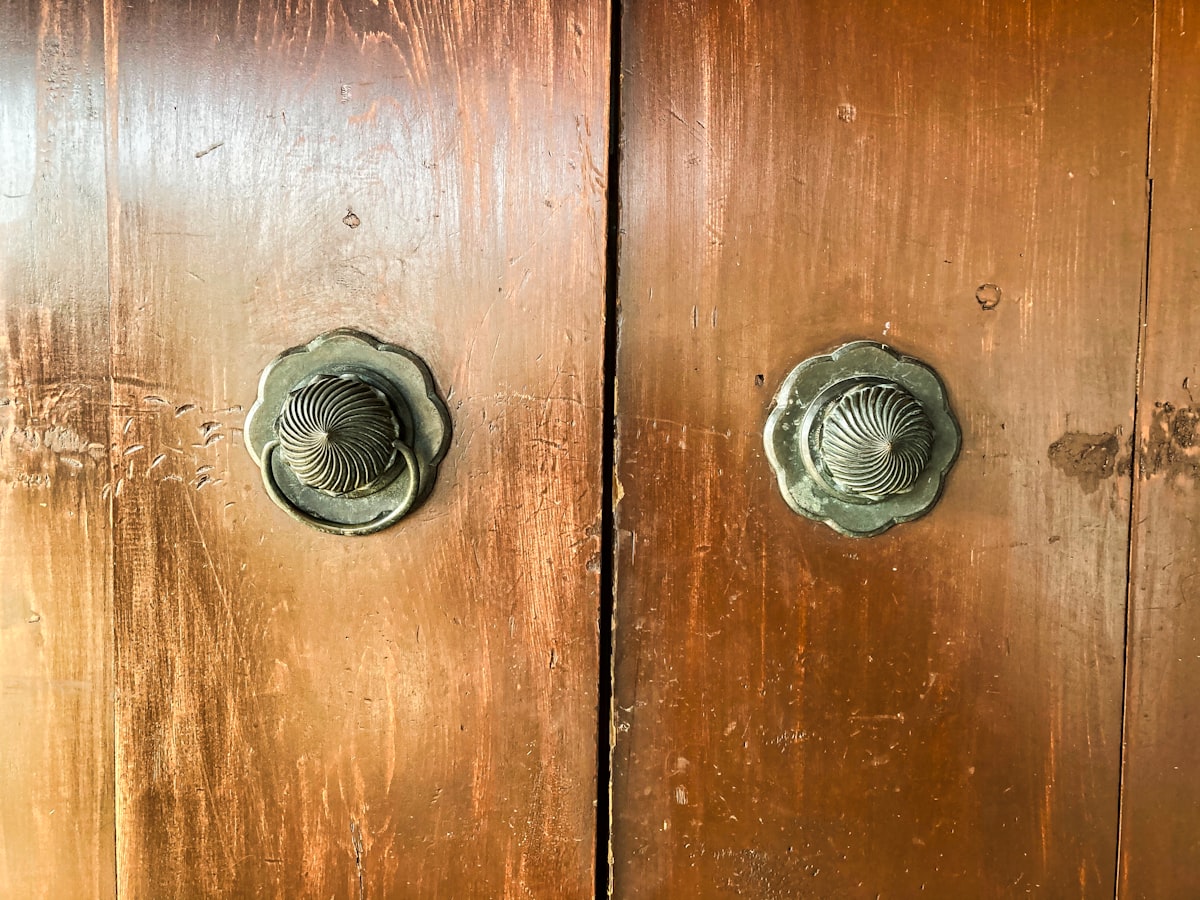 brown wooden door with silver door knob related to The Timeless Elegance of Antique Buffet Sideboards