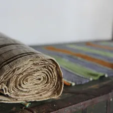 brown wooden round ornament on brown wooden table related to Striped Quilts and Coverlets