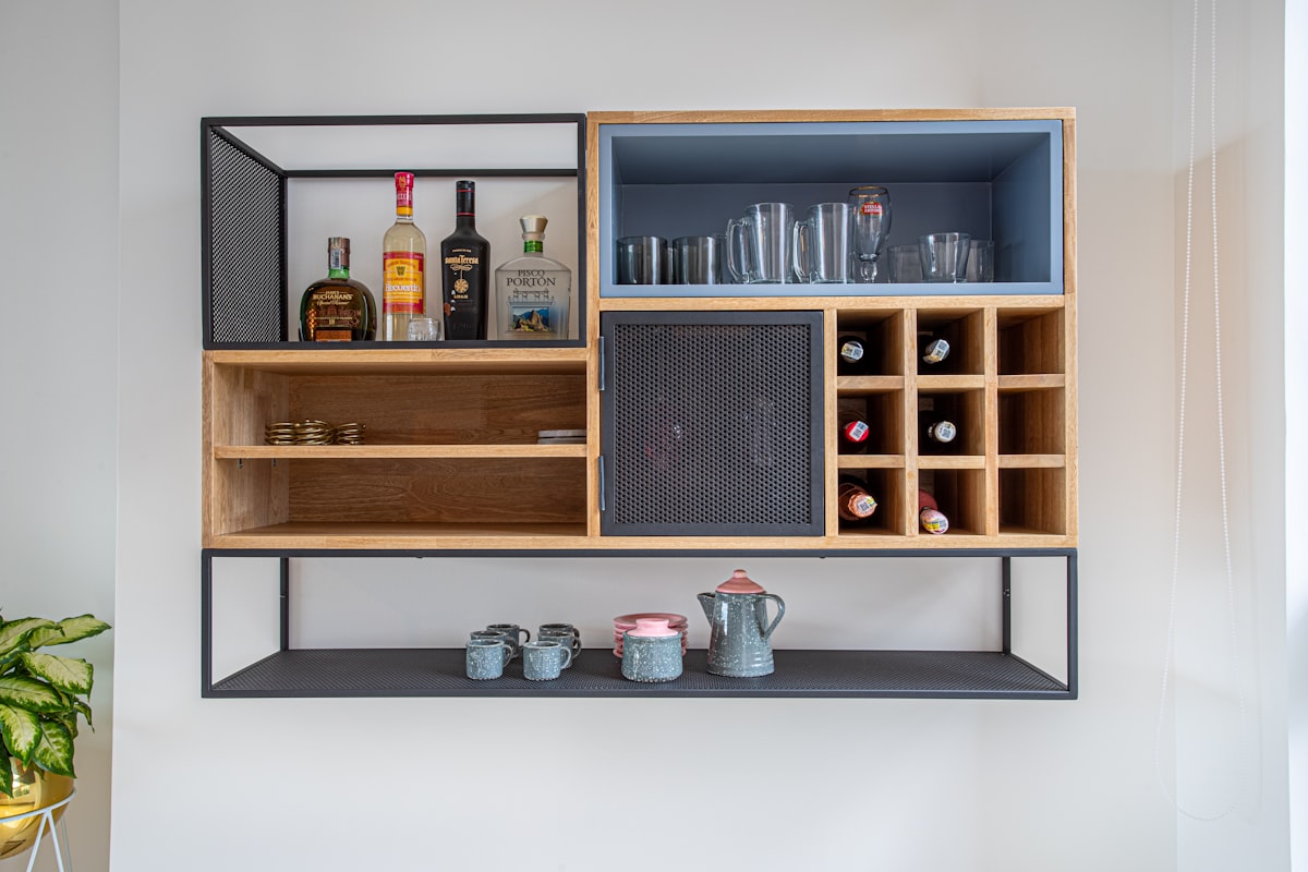 brown wooden shelf with bottles and jars related to Enhance Your Home Bar with a Sleek Sideboard Liquor Cabinet