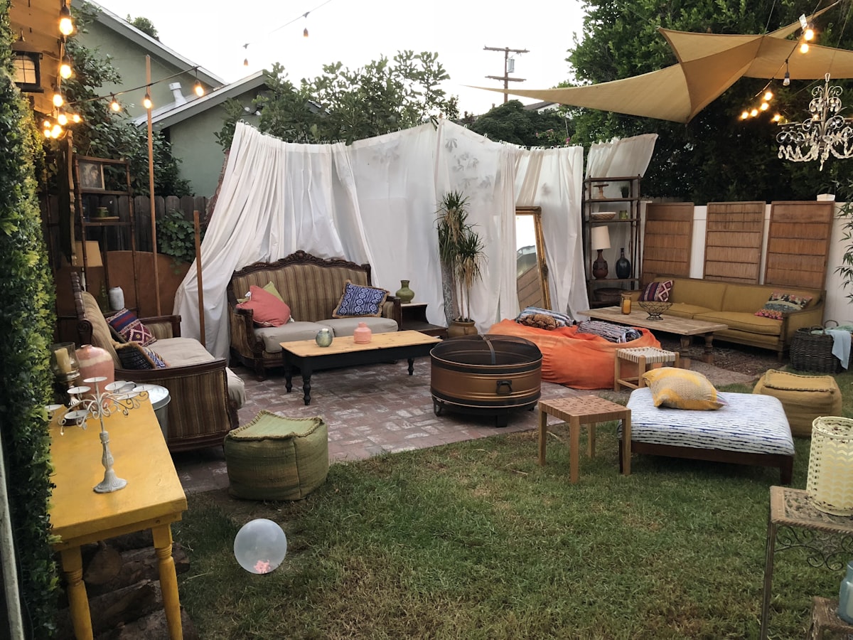 brown wooden table with chairs and white textile related to Revolutionizing Backyard Gatherings: The 360 Degree Chiminea