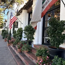Building entrance with american and california flags. related to Elevating Your Home's First Impression: Mastering Entryway Flower Arrangement