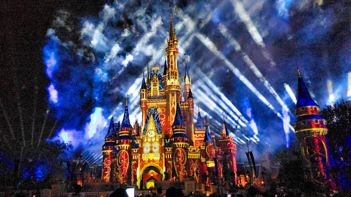 Castle illuminated with colorful lights and projections at night related to Dream Magic: Mickey Mouse Bedding Set for Your Little Ones