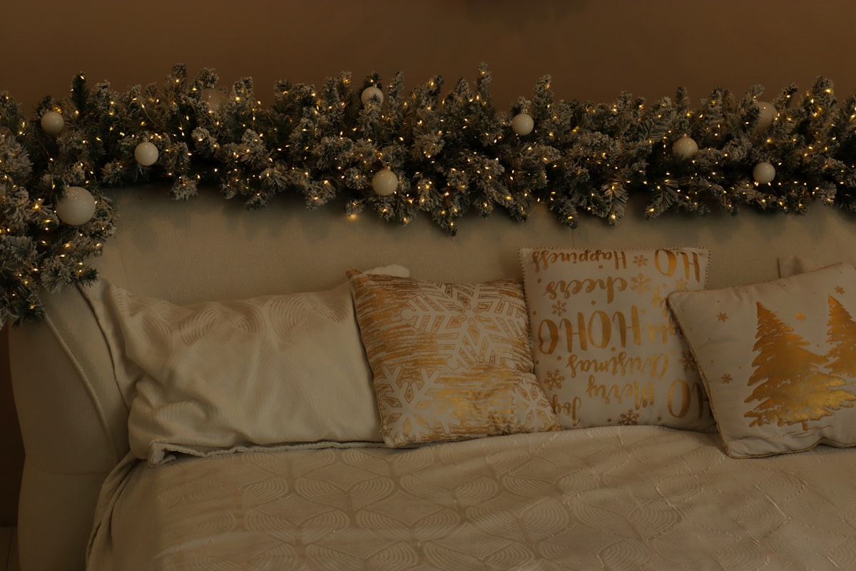Christmas garland with lights and ornaments above bed related to The Enchanting World of Lights Around Bed