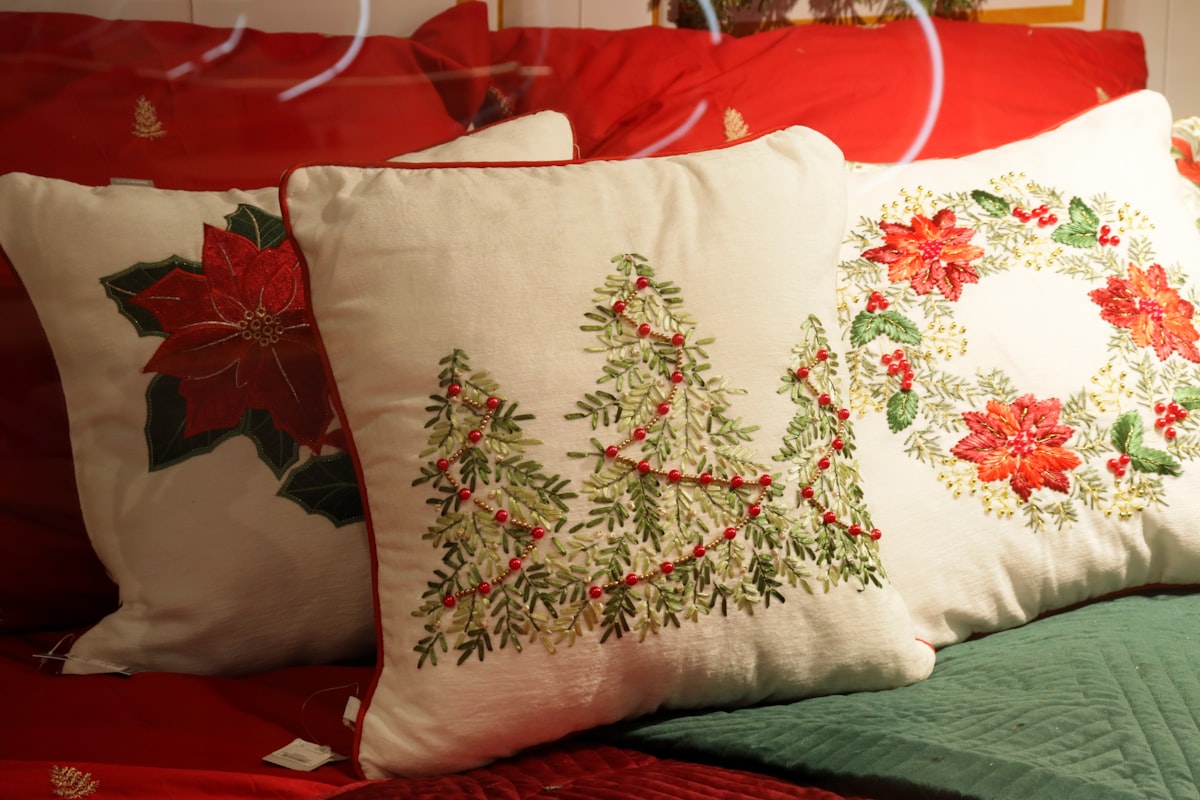 Christmas pillows with poinsettias and trees related to Deck the Halls with Christmas Bedding from Target