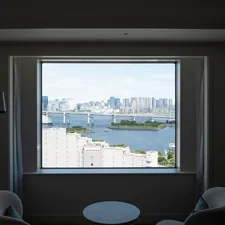 Cityscape view through a large window with chairs. related to Bay Window Valances: Elevating Your Home's Style