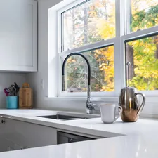 clean white kitchen with coffee cup and frenchpress on counter related to Valances for Kitchen Windows: Styles & Inspiration